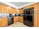 Well-lit kitchen showcasing wooden cabinets, granite countertops, and stainless steel appliances at 2900 N Atlantic Ave # 2003, Daytona Beach, FL 32118