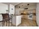 Cozy kitchen with tile floors, updated appliances, and bar seating at 2900 N Atlantic Ave # 2003, Daytona Beach, FL 32118