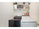 Laundry room featuring a washer, dryer, shelves and storage for cleaning supplies at 2900 N Atlantic Ave # 2003, Daytona Beach, FL 32118