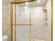 Close-up of a shower with decorative glass doors and bronze shower fixtures at 2900 N Atlantic Ave # 2003, Daytona Beach, FL 32118