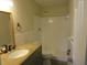 Bright bathroom featuring a beige granite countertop and a shower with white tiling at 2936 Lantern Dr, South Daytona, FL 32119