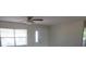 Open room with a ceiling fan, window with blinds, and view of doorway to other rooms at 2936 Lantern Dr, South Daytona, FL 32119