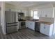 Modern kitchen with stainless steel appliances, white cabinets, and butcher block countertops at 2936 Lantern Dr, South Daytona, FL 32119