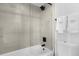 Modern bathroom featuring a glass shower with a rainfall showerhead, ceramic tiles, and white towels at 2947 S Atlantic Ave # 201, Daytona Beach Shores, FL 32118