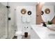 The bathroom features a modern shower, updated fixtures, a decorative mirror, and art accents at 2947 S Atlantic Ave # 201, Daytona Beach Shores, FL 32118