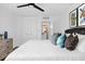 Bright bedroom with a ceiling fan, art pieces and a comfortable queen-sized bed at 2947 S Atlantic Ave # 201, Daytona Beach Shores, FL 32118