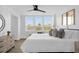 Bright bedroom featuring a large window with blinds, stylish decor with gold accents, and an open floor plan at 2947 S Atlantic Ave # 201, Daytona Beach Shores, FL 32118
