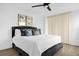 Comfortable bedroom featuring a plush bed, ceiling fan, and natural light with a private lanai at 2947 S Atlantic Ave # 201, Daytona Beach Shores, FL 32118