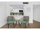 Cozy breakfast nook with wicker chairs overlooking the updated kitchen area with white cabinets at 2947 S Atlantic Ave # 201, Daytona Beach Shores, FL 32118