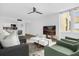 Open living space with modern furnishings, a ceiling fan, and a view of the kitchen area at 2947 S Atlantic Ave # 201, Daytona Beach Shores, FL 32118
