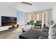 Inviting living room with contemporary decor, including a comfortable sectional sofa and a flat-screen TV at 2947 S Atlantic Ave # 201, Daytona Beach Shores, FL 32118