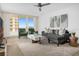 Bright living room featuring stylish furnishings, a ceiling fan, and a large sliding glass door to the balcony at 2947 S Atlantic Ave # 201, Daytona Beach Shores, FL 32118