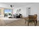 Open concept living area featuring modern furniture, contemporary decor, and access to the balcony at 2947 S Atlantic Ave # 201, Daytona Beach Shores, FL 32118
