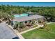 Beautiful clubhouse with a spacious pool and sun deck, surrounded by lush landscaping and ample parking at 302 Lamberton Ln, Deland, FL 32724