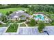 Community clubhouse featuring a pool and ample parking, beautifully landscaped with mature palm trees at 302 Lamberton Ln, Deland, FL 32724