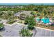 Aerial view of clubhouse with inviting pool, lush landscaping, and ample parking for community residents and their guests at 302 Lamberton Ln, Deland, FL 32724