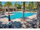 Resort-style pool surrounded by lounge chairs and palm trees, perfect for relaxation and recreation on sunny days at 302 Lamberton Ln, Deland, FL 32724