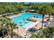Aerial view of the community pool area with splash features, lounge chairs, and lush landscaping all around at 302 Lamberton Ln, Deland, FL 32724