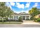 Charming single-story home with manicured landscaping, brick driveway, and a welcoming front entrance at 302 Lamberton Ln, Deland, FL 32724