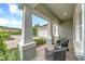 Inviting front porch features stately columns and brick pavers, perfect for enjoying quiet moments outdoors at 302 Lamberton Ln, Deland, FL 32724