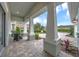 Covered front porch with tiled flooring and stylish seating, offering a comfortable outdoor living space at 302 Lamberton Ln, Deland, FL 32724