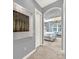 Hallway leading to a well-lit bedroom with neutral carpet and gray walls at 302 Lamberton Ln, Deland, FL 32724