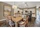 An open kitchen with an island and eat-in dining area featuring white cabinets and dark countertops at 302 Lamberton Ln, Deland, FL 32724