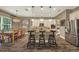 Gourmet kitchen with island, stainless steel appliances, and adjacent dining area at 302 Lamberton Ln, Deland, FL 32724