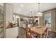 A spacious open floorplan kitchen and dining area with wood-look floors and lots of natural light at 302 Lamberton Ln, Deland, FL 32724