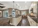A stylish open kitchen with a large island, modern appliances, and dark wood-look flooring at 302 Lamberton Ln, Deland, FL 32724