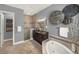 A main bathroom featuring a soaking tub, a tiled shower, and dark wood cabinetry at 302 Lamberton Ln, Deland, FL 32724