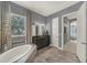 A main bathroom with a soaking tub, dark wood cabinets and tile flooring at 302 Lamberton Ln, Deland, FL 32724