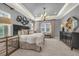 The main bedroom has neutral carpet, tray ceilings, and a chandelier at 302 Lamberton Ln, Deland, FL 32724