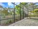 Screened-in pool area with brick patio offers a beautiful outdoor space with views of the surrounding landscape at 302 Lamberton Ln, Deland, FL 32724