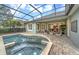 Lovely screened-in pool area with a brick patio and comfortable seating, ideal for outdoor entertaining at 302 Lamberton Ln, Deland, FL 32724