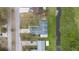 A top-down view of the home showcases a large lot with mature landscaping and proximity to a canal at 303 E Floral Ave, Eustis, FL 32726