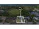 Aerial view of property near a beautiful lake and surrounded by lush green trees at 303 E Floral Ave, Eustis, FL 32726