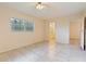 Bedroom featuring neutral walls, tile flooring, and a window for natural light at 303 E Floral Ave, Eustis, FL 32726