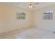 Bedroom showcasing tile floors, neutral walls and two windows at 303 E Floral Ave, Eustis, FL 32726