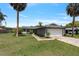 Lovely single-story home featuring a two-car garage, mature landscaping and a well-maintained lawn at 303 E Floral Ave, Eustis, FL 32726