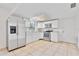 Bright kitchen featuring stainless steel appliances, white cabinets and tile flooring at 303 E Floral Ave, Eustis, FL 32726