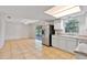 Bright and airy kitchen featuring white cabinets, stainless steel appliances and tile flooring at 303 E Floral Ave, Eustis, FL 32726
