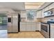 Spacious kitchen featuring stainless steel appliances, white cabinets and tile flooring at 303 E Floral Ave, Eustis, FL 32726