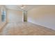 Bright living room with tile flooring, a ceiling fan, and lots of natural light from a large window at 303 E Floral Ave, Eustis, FL 32726