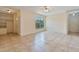 Spacious living room featuring tiled floors, large windows and a ceiling fan at 303 E Floral Ave, Eustis, FL 32726