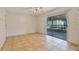 Living room with ceiling fan, and sliding door access to patio at 303 E Floral Ave, Eustis, FL 32726
