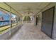 Enclosed patio featuring a ceiling fan, screen panels, tile flooring, and sliding glass door access to the interior at 303 E Floral Ave, Eustis, FL 32726