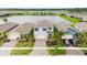 Aerial view of a home with a pond view, lush landscaping, and a two car garage at 3120 Areca Ave, New Smyrna Beach, FL 32168