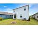 Back of home features a fire pit and beautiful landscaping at 3120 Areca Ave, New Smyrna Beach, FL 32168