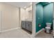 Modern bathroom with vanity, gray cabinets, granite countertops, and a separate toilet area at 3120 Areca Ave, New Smyrna Beach, FL 32168
